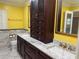 Bathroom with dual sinks, custom wood cabinetry, granite counters, providing space and sophistication at 645 Peachwood Dr, Altamonte Springs, FL 32714