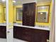 The renovated bathroom boasts dual sinks, granite countertops, custom wood cabinet and ample storage at 645 Peachwood Dr, Altamonte Springs, FL 32714
