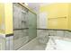 Bathroom showcasing the white tile surround and glass enclosed tub and shower at 645 Peachwood Dr, Altamonte Springs, FL 32714