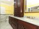 Bathroom features marble countertops, wood cabinets, and gold hardware accents at 645 Peachwood Dr, Altamonte Springs, FL 32714