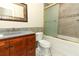 A bathroom with granite countertops, a wooden cabinet, and a glass-enclosed shower with tiled accents at 645 Peachwood Dr, Altamonte Springs, FL 32714