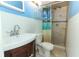 Cozy bathroom with tiled shower, white vanity, and blue accent walls at 645 Peachwood Dr, Altamonte Springs, FL 32714