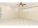 Spacious bedroom with white tile flooring, neutral walls, and modern ceiling fan at 645 Peachwood Dr, Altamonte Springs, FL 32714