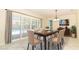 Dining area with table, six chairs, and sliding glass doors overlooking a refreshing pool view at 645 Peachwood Dr, Altamonte Springs, FL 32714