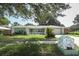 Charming home with a well-maintained lawn, a decorative mailbox, and a welcoming, quaint front porch at 645 Peachwood Dr, Altamonte Springs, FL 32714