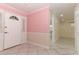 Front foyer with patterned pink wallpaper, white front door with sidelights, and tile flooring at 645 Peachwood Dr, Altamonte Springs, FL 32714