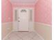 Front foyer with patterned pink wallpaper, white door with sidelights, and tile flooring at 645 Peachwood Dr, Altamonte Springs, FL 32714