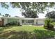 Charming single-story home with a well-manicured lawn, white picket fence, and attached garage at 645 Peachwood Dr, Altamonte Springs, FL 32714
