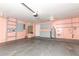 Spacious garage with shelving, cabinets, and utility sink, perfect for storage and projects at 645 Peachwood Dr, Altamonte Springs, FL 32714
