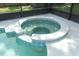 Close-up of a hot tub with blue accents sitting next to a sparkling pool, perfect for relaxation at 645 Peachwood Dr, Altamonte Springs, FL 32714