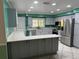This open kitchen features stainless steel appliances, gray cabinets and eat-in counter space at 645 Peachwood Dr, Altamonte Springs, FL 32714