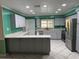The bright kitchen features stainless steel appliances, gray cabinets, an eat-in counter, and modern design at 645 Peachwood Dr, Altamonte Springs, FL 32714