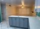 Bright kitchen featuring a large island with quartz countertops, cabinets, and tile flooring at 645 Peachwood Dr, Altamonte Springs, FL 32714