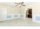 Light filled living room with tile flooring and blue paneled walls is adjacent to another room at 645 Peachwood Dr, Altamonte Springs, FL 32714