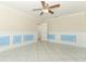 Light filled living room with tile flooring, blue paneled walls, and ceiling fan at 645 Peachwood Dr, Altamonte Springs, FL 32714