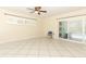 Open living room showcasing tile flooring, a modern ceiling fan, and sliding glass doors at 645 Peachwood Dr, Altamonte Springs, FL 32714