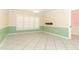Bright living room with white tile floor, plantation shutters, and two-tone green and cream walls at 645 Peachwood Dr, Altamonte Springs, FL 32714