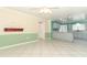 Bright living room with tile flooring, light gray cabinetry, and painted two-tone green and cream walls at 645 Peachwood Dr, Altamonte Springs, FL 32714