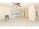 Open living room showcasing tile flooring, a modern ceiling fan, and sliding glass doors at 645 Peachwood Dr, Altamonte Springs, FL 32714