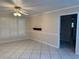 Bright living room featuring plantation shutters, a ceiling fan, and tile flooring at 645 Peachwood Dr, Altamonte Springs, FL 32714