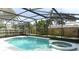 The backyard features a screened-in pool and a jacuzzi with a fenced in yard perfect for relaxation and entertaining at 645 Peachwood Dr, Altamonte Springs, FL 32714