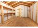 Empty shed interior with wooden floors, beams, and shelving offering storage solutions at 645 Peachwood Dr, Altamonte Springs, FL 32714