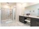 This spacious bathroom has a walk-in shower and a vanity with lots of counter space at 671 Drop Shot Dr, Davenport, FL 33896