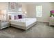 This primary bedroom is well-lit with neutral decor, carpet flooring, and a plush king-size bed at 671 Drop Shot Dr, Davenport, FL 33896