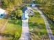 Aerial view showcases the home's location, carport, and surrounding greenery at 6975 Maverick Trl, St Cloud, FL 34771