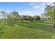 Expansive backyard with lush green grass, mature trees, and an open sunny space at 6975 Maverick Trl, St Cloud, FL 34771