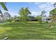 Large grassy yard with mature trees, perfect for outdoor activities and enjoying nature at 6975 Maverick Trl, St Cloud, FL 34771