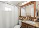 Cozy bathroom featuring tiled walls, shower with curtain, and granite countertop sink at 6975 Maverick Trl, St Cloud, FL 34771