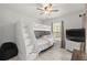 Bedroom with a bunk bed, ceiling fan, natural light, and tile flooring at 6975 Maverick Trl, St Cloud, FL 34771