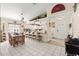 Open-concept dining area with rustic dining set, bar seating, and access to the front entrance at 6975 Maverick Trl, St Cloud, FL 34771