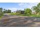 Spacious home with a long driveway surrounded by a beautiful lawn and mature trees at 6975 Maverick Trl, St Cloud, FL 34771