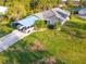 Charming home with a covered carport, lush lawn, and mature trees at 6975 Maverick Trl, St Cloud, FL 34771