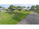 Attractive home featuring a spacious yard, covered parking, and a long driveway on a bright day at 6975 Maverick Trl, St Cloud, FL 34771