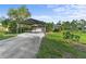 Charming single-story home featuring a covered parking area and well-maintained landscaping on a sunny day at 6975 Maverick Trl, St Cloud, FL 34771