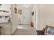 Inviting hallway with tile flooring, leading to the kitchen and featuring decor accents at 6975 Maverick Trl, St Cloud, FL 34771