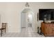 Open hallway leading to a bathroom, with tile flooring, closet, and view of an adjacent space at 6975 Maverick Trl, St Cloud, FL 34771