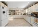 Spacious kitchen with white cabinets, ample counter space, and modern appliances, open to dining area at 6975 Maverick Trl, St Cloud, FL 34771