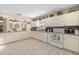 Spacious kitchen featuring white cabinetry, granite countertops, tile floors, and modern appliances at 6975 Maverick Trl, St Cloud, FL 34771