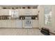 Bright kitchen featuring white cabinetry, modern appliances, and neutral countertops at 6975 Maverick Trl, St Cloud, FL 34771