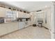 Well-lit kitchen with white cabinets, granite countertops, stainless steel appliances and tile flooring at 6975 Maverick Trl, St Cloud, FL 34771