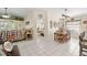 Bright open-concept living room and dining area featuring tile flooring and comfortable furnishings at 6975 Maverick Trl, St Cloud, FL 34771