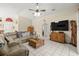 Welcoming living room featuring comfortable sectional sofa and TV entertainment center at 6975 Maverick Trl, St Cloud, FL 34771
