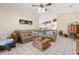 Relaxing living room featuring cozy sectional sofa and open view to the kitchen at 6975 Maverick Trl, St Cloud, FL 34771