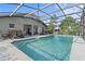 Backyard with a screened-in pool area, with lounge chairs, and lush greenery at 6975 Maverick Trl, St Cloud, FL 34771