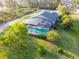 Aerial view of the pool with screened-in lanai and spacious backyard with mature landscaping at 6975 Maverick Trl, St Cloud, FL 34771