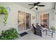 Covered porch with seating area, ceiling fan, potted plants, and access to the pool area at 6975 Maverick Trl, St Cloud, FL 34771